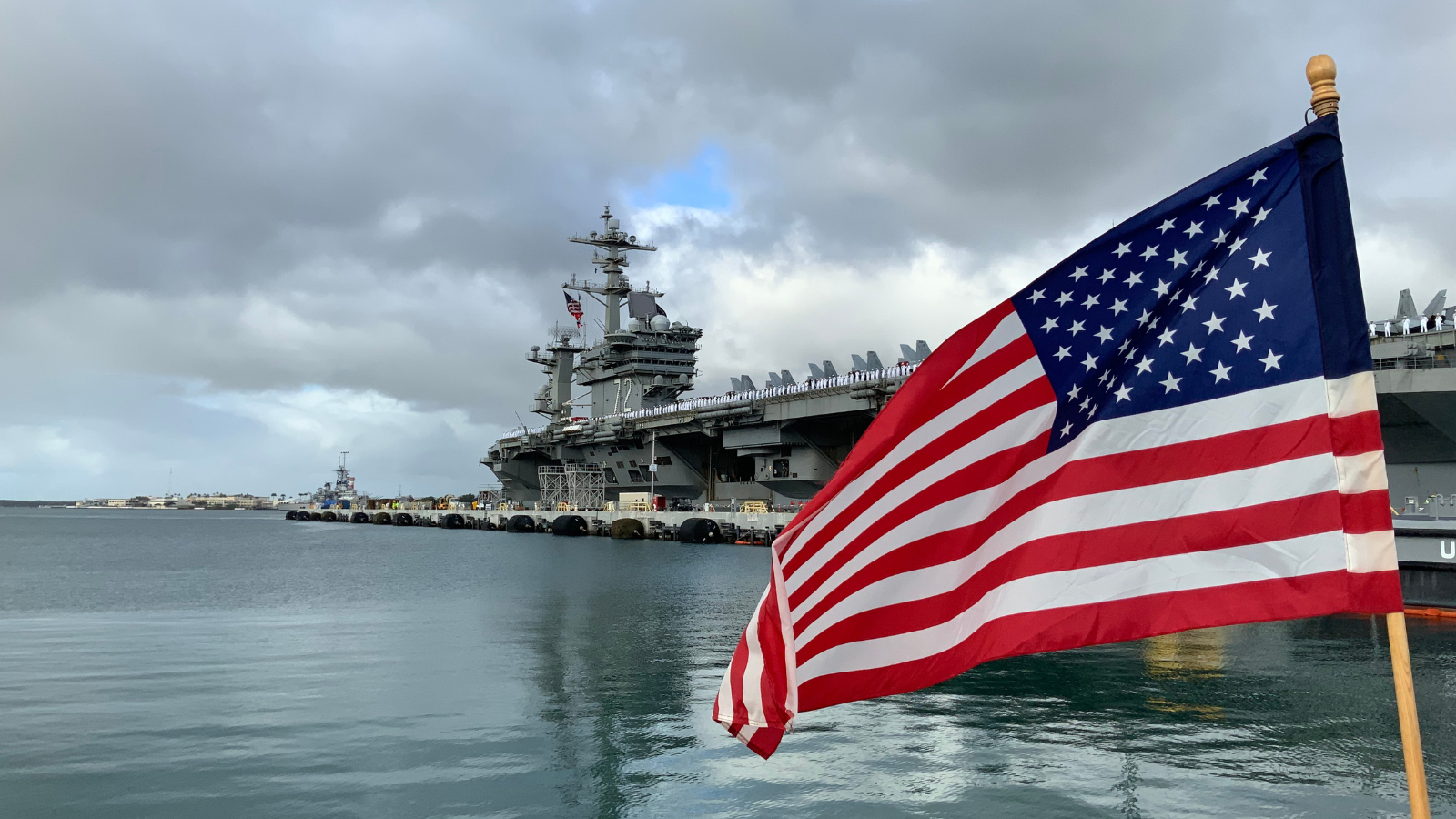 aircraft carrier pulling into pearl harbor