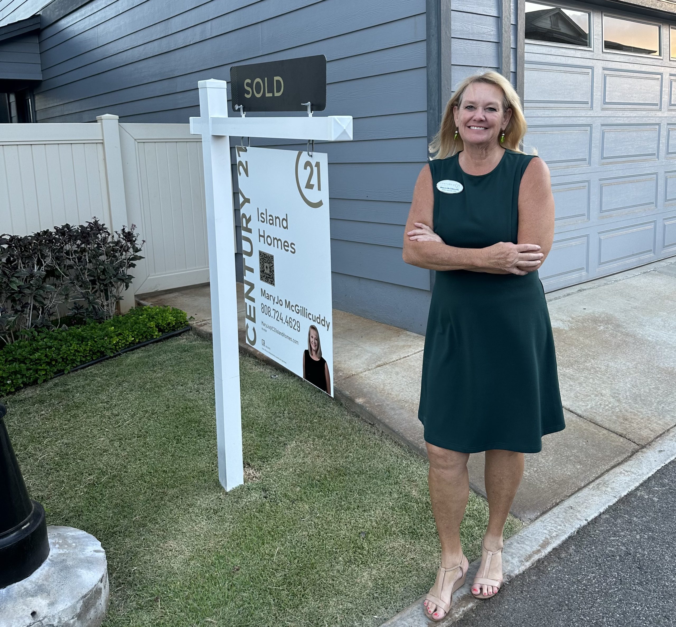 maryjo mcgillicuddy realtor associate next to a sold sign