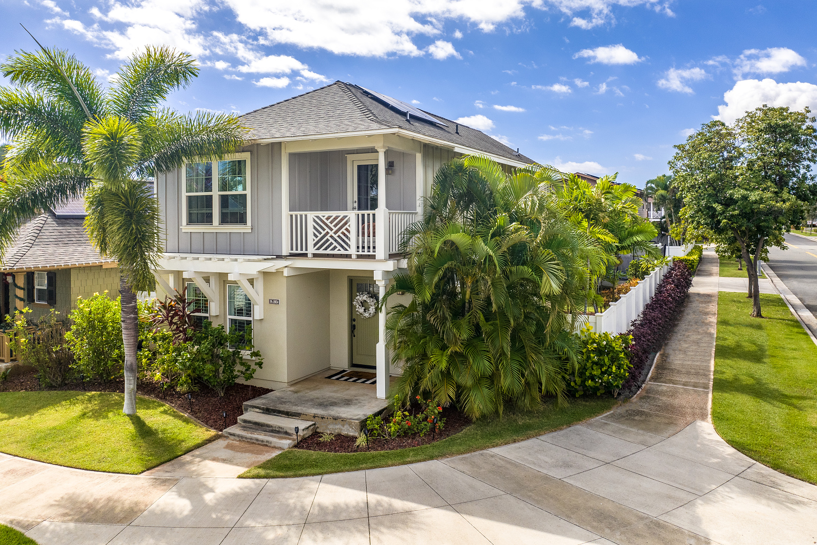 Corner-lot single-family home in Ocean Pointe, Ewa Beach with curbside parking pad and landscaped frontage