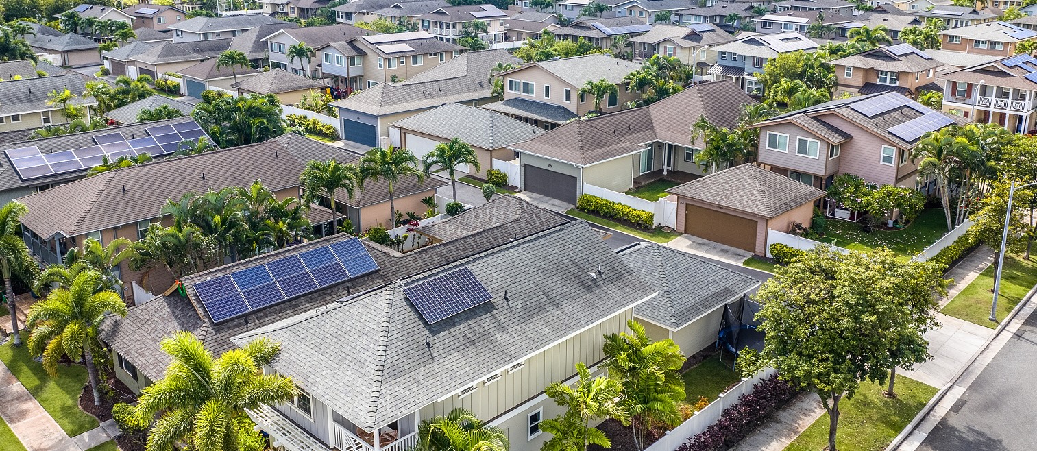 Single family home in Ewa Beach Hawaii with palm trees and landscaped yard